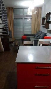 a living room with a red cabinet and a couch at Ático,loft ,duplex in Madrid