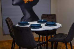 a table with four blue dishes on top of it at Petar's aparment luxury new in Skopje