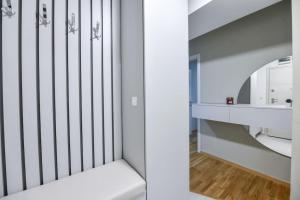 a room with a crib with a mirror at Petar's aparment luxury new in Skopje