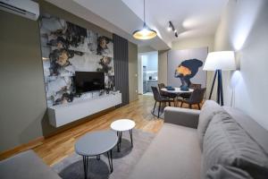 a living room with a couch and a tv and a table at Petar's aparment luxury new in Skopje
