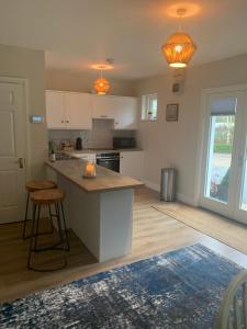 a kitchen with white cabinets and a counter top at The Mews in Newbridge
