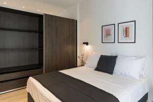 a bedroom with a large bed and a tv at Voda Luxury Residence #202 in Athens