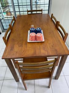 a wooden table with three candles on a plate on it at D’Surati River View Homestay 