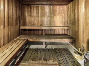 a sauna with wooden walls and a wooden floor at Scarborough Beach Resort Brisbane in Scarborough +43 photos