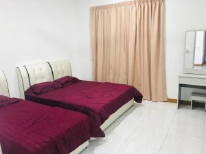 a bedroom with two beds and a piano at SUNNY HOMESTAY KUALA SELANGOR in Kuala Selangor