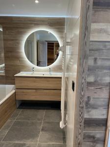 a bathroom with a sink and a mirror at Magnifique chalet sur les pistes, le Paradis c'est ici ! in La Toussuire