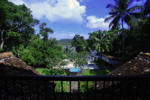 a view from the balcony of a resort with a pool at Galle Henna Estate in Unawatuna