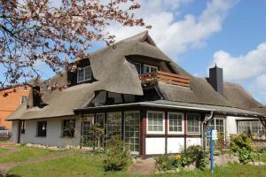 a large house with a thatched roof at Haus 1795 Stieglitz in Wustrow