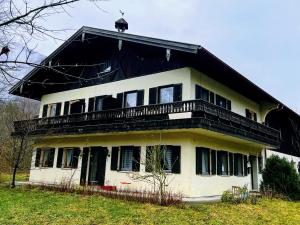a house with a balcony on top of it at Pension Luger in Aschau im Chiemgau