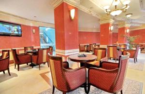 a restaurant with tables and chairs in a room at Private Apartment in Grand Monastery in Pamporovo