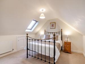 a bedroom with a bed and a skylight at The Old Combine Shed in Huby
