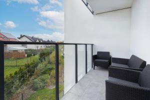 a balcony with two chairs and a view at Apartments Beaufort Estate by Renters in Gdynia