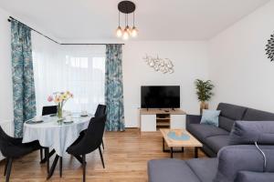 a living room with a couch and a table at Apartments Beaufort Estate by Renters in Gdynia