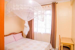 Voodi või voodid majutusasutuse Nairobi Airport Apartments toas