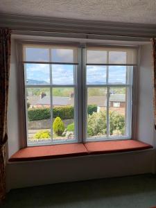 a window with a window seat in a room at Squirrel Away At Leven House in Crieff