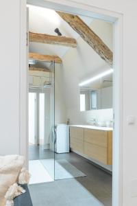 a bathroom with a glass shower and a sink at Beautiful Penthouse - City Center in Graz