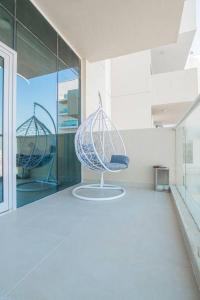 a room with two chairs sitting in a building at Spacious modern 2 bedroom apartment in Dubai
