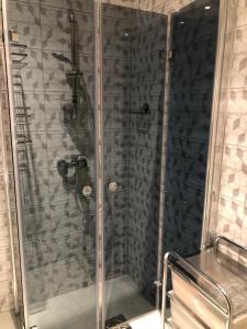 a shower with a glass door in a bathroom at Uku Villa in Pärnu