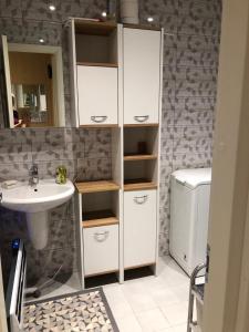 a bathroom with a sink and a white cabinet at Uku Villa in Pärnu