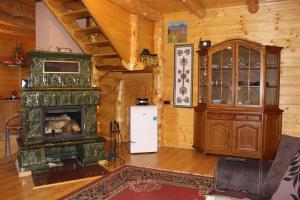 a living room with a fireplace and a stove at Domek na Zabawie in Milówka