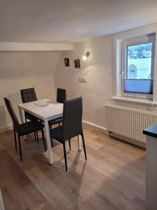 a dining room with a table and chairs and a window at Mei Auszeit in Zella-Mehlis