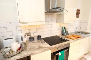 a kitchen with a sink and a counter top at The Lottbridge in Eastbourne
