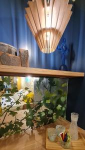 a shelf with a painting on it with a light at Villa Aigarden maison d'hôtes in Avignon