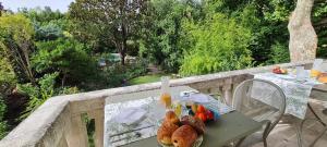 a table with bread and fruit on a balcony at Villa Aigarden in Avignon +42 photos