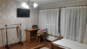 Televízia a/alebo spoločenská miestnosť v ubytovaní Villa Lena