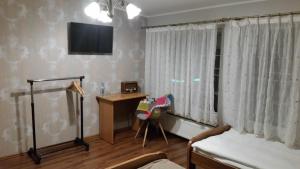 Televízia a/alebo spoločenská miestnosť v ubytovaní Villa Lena