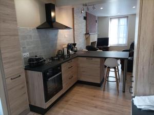 a kitchen with a stove and a counter top at Gite de la Croix de la Passion in Vailly-sur-Sauldre