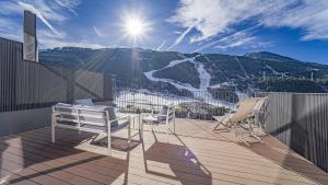 a balcony with chairs and a view of a mountain at KOKONO Luxury Ski Chalet Andorra, El Tarter in El Tarter