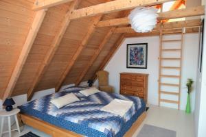 a bedroom with a bed and a wooden ceiling at Ferienhaus Sandmohn in Kellenhusen