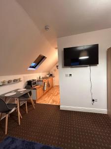 A television and/or entertainment centre at Bv Comfy Attic Studio At Deighton Huddersfield