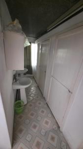 a small bathroom with a sink and a toilet at CHEZ MADAM ROSE in Le Morne