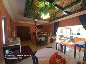 a room with a bed and a dining room at Maison Leila chambres d hotes in Midoun