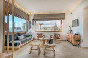 a living room with a couch and a table at Damianos Mykonos Hotel in Mýkonos City