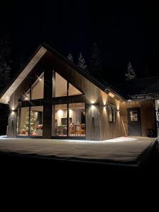 een huis verlicht in de nacht met lichten bij Nybyggd 8-bäddars skidstuga i Lofsdalen in Lofsdalen