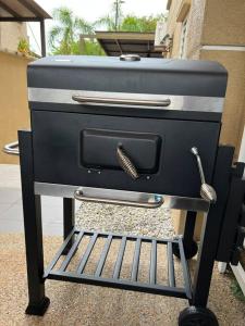 a black grill with a spatula on top of it at Luxury House near KL City for Vacation and Retreat in Ampang