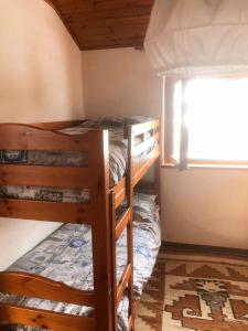 A bed or beds in a room at Rododendro- Bluchalet