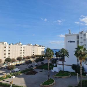 a view of a parking lot in front of a building at Tabbu ibiza apartments in Playa d'en Bossa