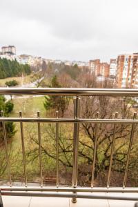 a window with a view of a field and buildings at KRISSTY Apartment in Veliko Tŭrnovo