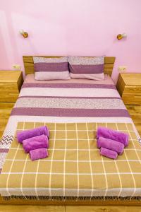 a bed with purple pillows on it in a room at KRISSTY Apartment in Veliko Tŭrnovo