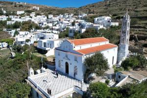 an aerial view of a town with a clock tower at Apopsis Tinos View in Triandáros
