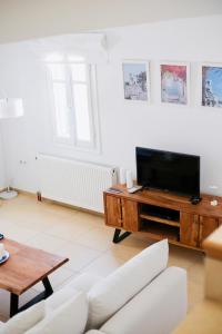 a living room with a tv and a couch at Villa Giulia, Seaview Villa near Chora in Ios Chora +22 photos