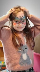 a young girl with face painting of a cat at Willa Pod Janowcem in Stronie Śląskie