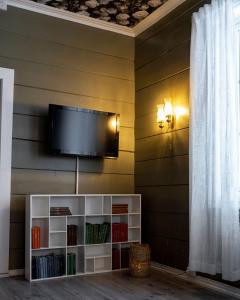 a flat screen tv hanging on a wall at Vollsnes Gjestehus in Stryn +33 photos