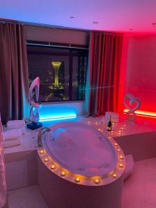 a large bathroom with a large tub with lights at Beijing Palace Soluxe Hotel Astana in Astana