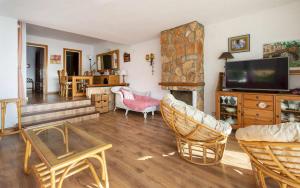 a living room with a television and a fireplace at Xalupa Salions Vistas in Tossa de Mar