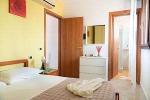 a bedroom with a bed and a bathroom at Residence Yellow in Rimini